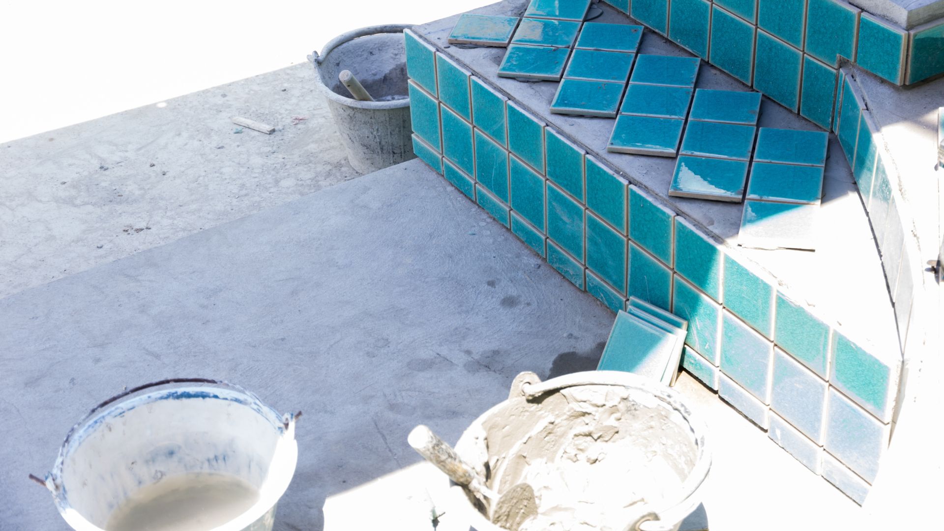 Turquoise tiles and cement buckets during home renovation project